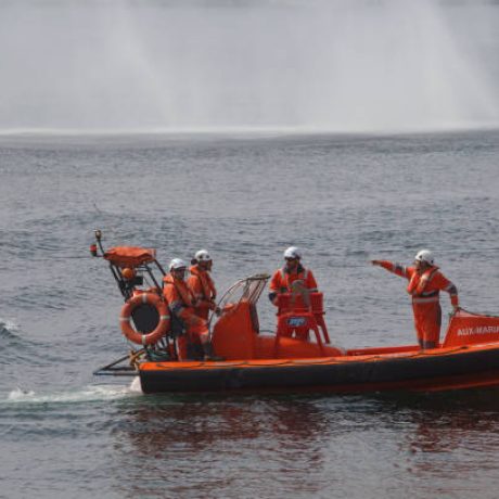 Coruna-Spain.Small maritime rescue boat with several rescuers making gestures during a rescue on August 28, 2021